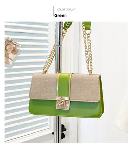 Detail of green leather shoulder bag with beige woven flap and gold chain strap