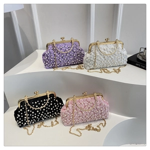 Detail of evening clutches in four colors with floral lace, pearls and gold chain straps