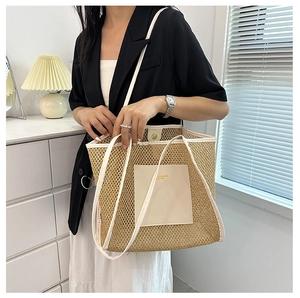 Close-up of woven mesh tote bag featuring white leather trim and logo patch detail