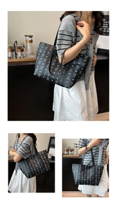 Detail of a large black tote bag with white bear monogram print for office commute style