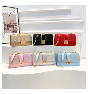 Detail view of sparkly sequin crossbody bags in six vibrant colors with gold chain straps