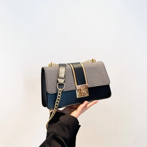 Minimalist chain shoulder bag with grey fabric and black leather contrast and gold clasp