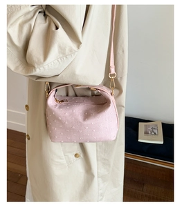 Pink textured crossbody bag for women with stylish dotted fabric design