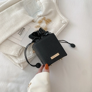 Mini black lychee leather crossbody bag with gold chain and drawstring closure
