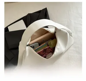 Internal view of a large white tote bag showing storage for a tablet and daily items