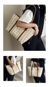Detail view of large retro tote bag with bear patterns and dark brown leather straps