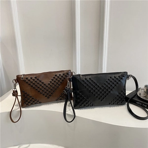 Minimalist envelope crossbody bag with V-shaped rivet studs in black and brown leather