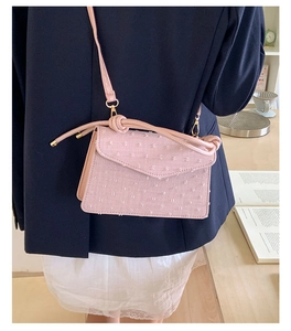 Stylish pink textured small square crossbody bag for women with elegant knot strap detail