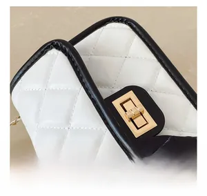 Detail of white quilted bag with golden lock and H-logo printed silk scarf accessory