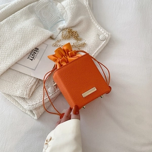 Vibrant orange lychee pattern mini box bag with gold chain and drawstring closure
