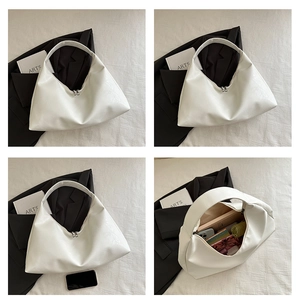 Detailed views of a white crescent tote bag showing spacious interior and sleek PU leather