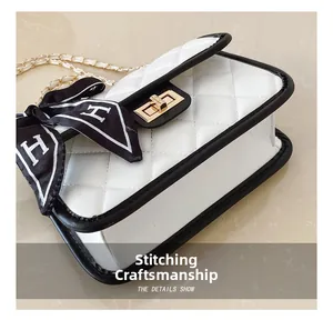 Detail of quilted white shoulder bag with black trim and elegant silk scarf accessory