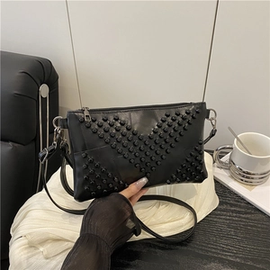 Fashionable black studded crossbody bag with geometric V-pattern and leather texture