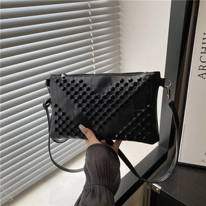Fashionable black studded PU leather crossbody bag with geometric rivet patterns