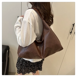 Detail shot of the dark brown PU leather shoulder bag with natural wrinkled texture