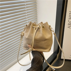 Minimalist beige drawstring bucket bag with adjustable shoulder strap and gold hardware