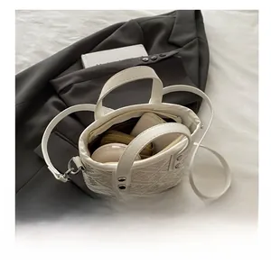 Interior view showing the storage capacity of the white bucket bag with items