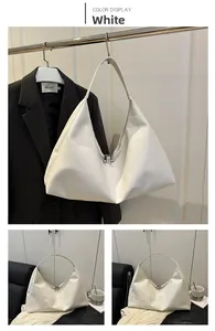 Detail of white large capacity tote bag with pleated texture and silver zipper