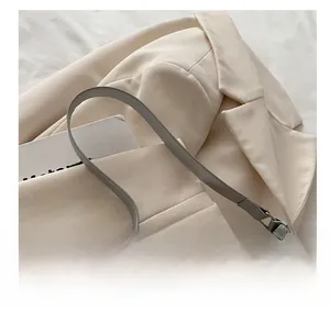 Detail of the glittering grey handbag fabric with high-quality zipper and smooth leather handle