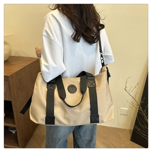 Rear view of a khaki large-capacity tote bag with adjustable black shoulder straps