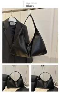 Detail view of large black glossy synthetic leather hobo bag with zipper closure for commuting