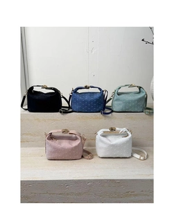Set of five textured shoulder bags in pastel colors shown on stone steps detail