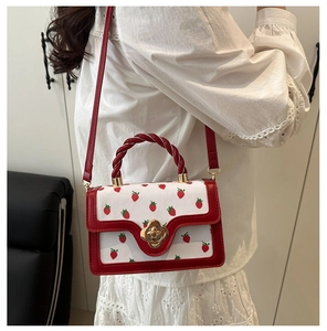 Trendy sweet white crossbody bag featuring red strawberry print and a twisted handle