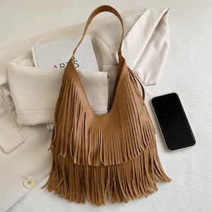 Detailed view of brown leather fringe hobo bag with tiered tassel design