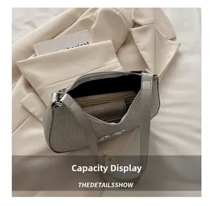 Interior view of silver crescent bag showing capacity for phone and essentials