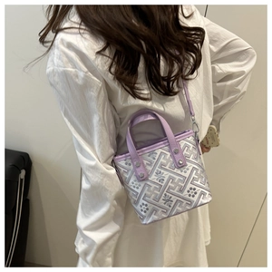 Detail view of the mini tote bag with abstract floral patterns and light purple straps