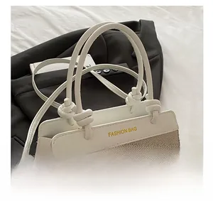 Detail of white PU leather and beige woven fabric bucket bag with stylish knotted handle