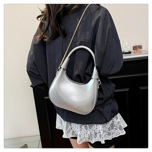 Close-up of silver hobo bag with sleek metallic finish and elegant gold chain strap
