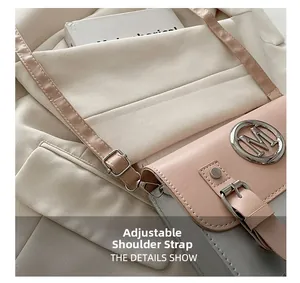 Detail showing the adjustable pink shoulder strap with a silver buckle on a crossbody bag