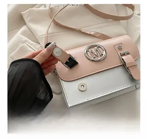 Close-up of pink and silver square bag showing silver M hardware and fine texture