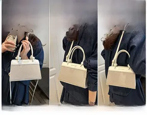 Detailed views of bi-color linen shell bag showing handheld, shoulder and crossbody styles