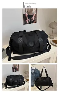 Detail of waterproof black Oxford travel bag with reinforced handles and adjustable strap