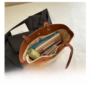 Detail showing the large interior capacity of this woven tote bag with leather trim