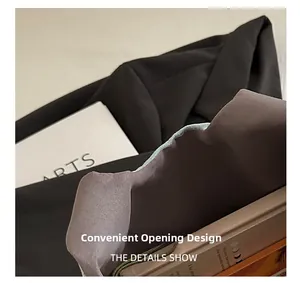 Detail of convenient opening design on large black canvas tote bag with textile texture