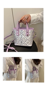 Detail of purple plaid bucket bag with embroidery, showing handle and crossbody style