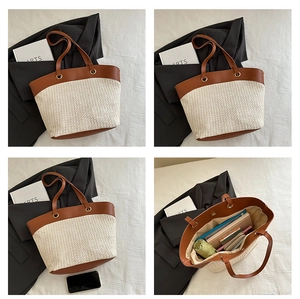 Detail view of woven straw tote bag with brown leather straps and spacious interior