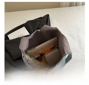 Top view of large capacity light blue tote bag showing interior storage for books and umbrella