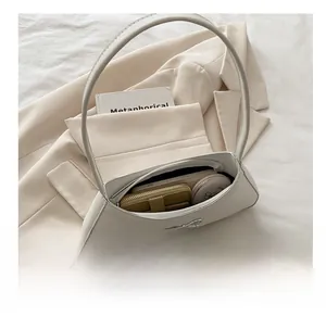 Interior view of off-white baguette bag showing storage capacity for wallet and cosmetics