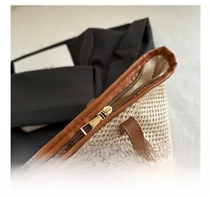 Detail shot of top zipper closure and inner lining on woven straw tote beach bag