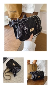 Detail view of quilted leather chain bag with gold buckle and H logo silk scarf