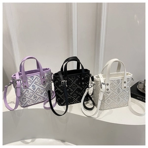 Detailed view of mini tote bags in purple, black, and white with geometric patterns