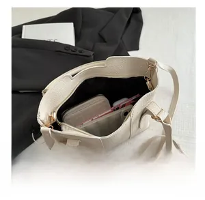 Detailed top view of a white leather bucket bag interior showing spacious capacity