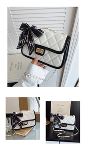 Close-up of quilted diamond pattern leather bag with gold clasp and silk scarf handle