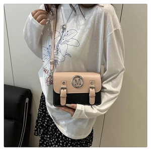 Detail of color-block flap bag with metal M logo and silver decorative buckles