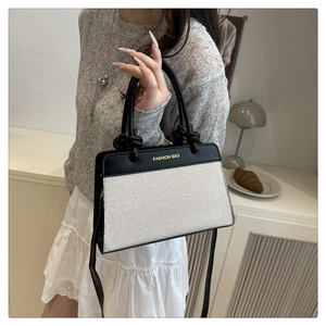 Fashion contrast handbag with black leather and white woven texture in a lifestyle setting