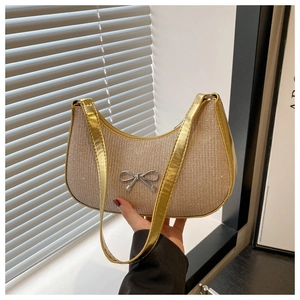 Close-up of crescent hobo bag with sparkling sequins and silver bow metal buckle